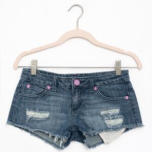 JUNIOR’S size 5 “NO” denim cutoff shorts with pink paisley accent pockets